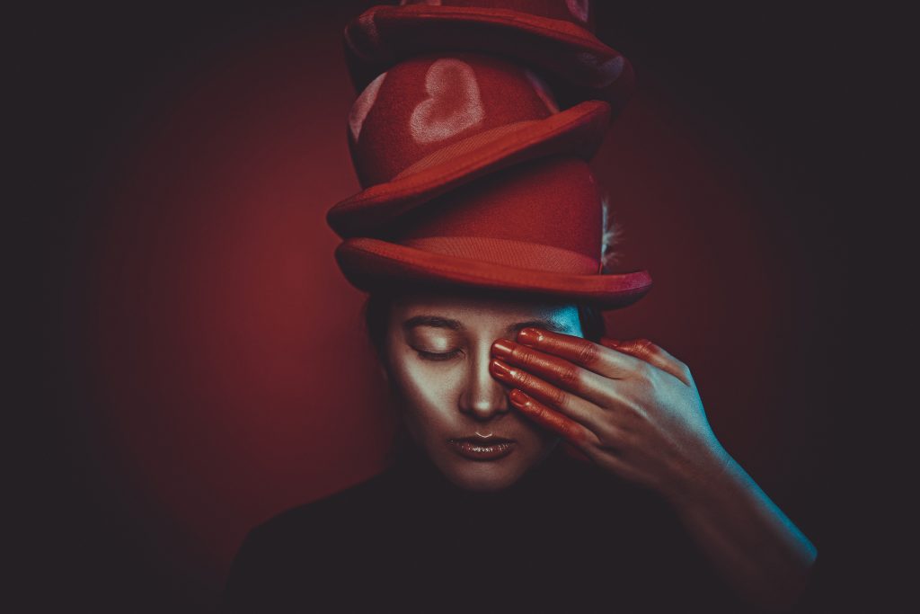 portrait-einer-frau-mit-roten-hüten-und-herzen